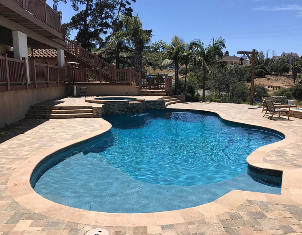 Modern pool remodel featuring spa spillover, new tile, and ambient lighting in Denton, TX