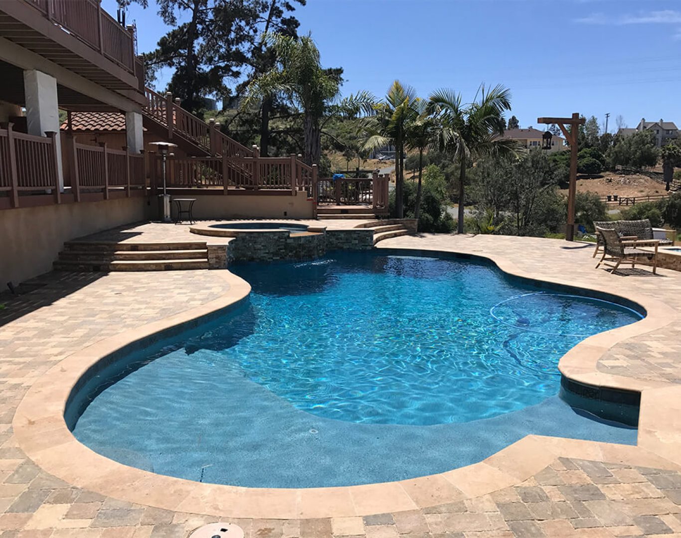 Modern pool remodel featuring spa spillover, new tile, and ambient lighting in Denton, TX