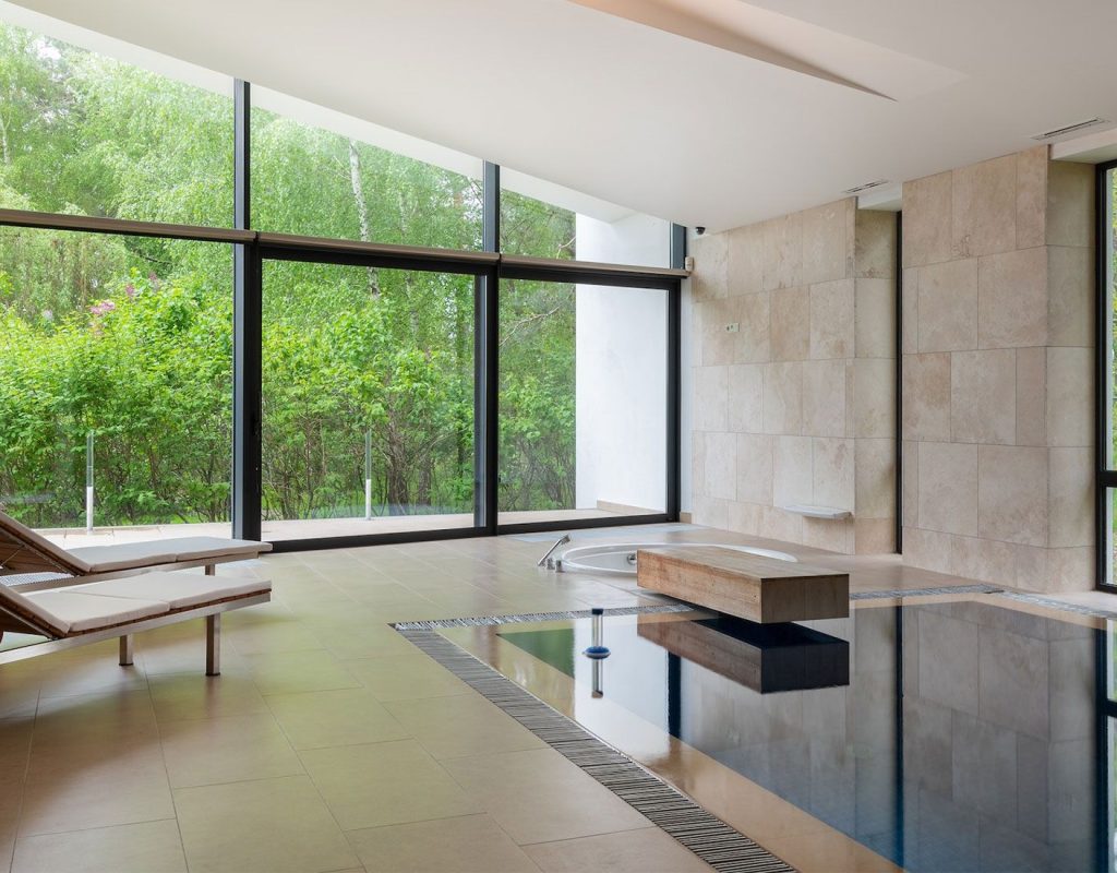 Modern pool remodel featuring spa spillover, new tile, and ambient lighting in Denton, TX