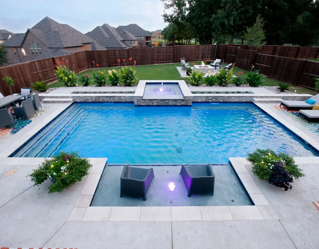 Modern pool remodel featuring spa spillover, new tile, and ambient lighting in Denton, TX