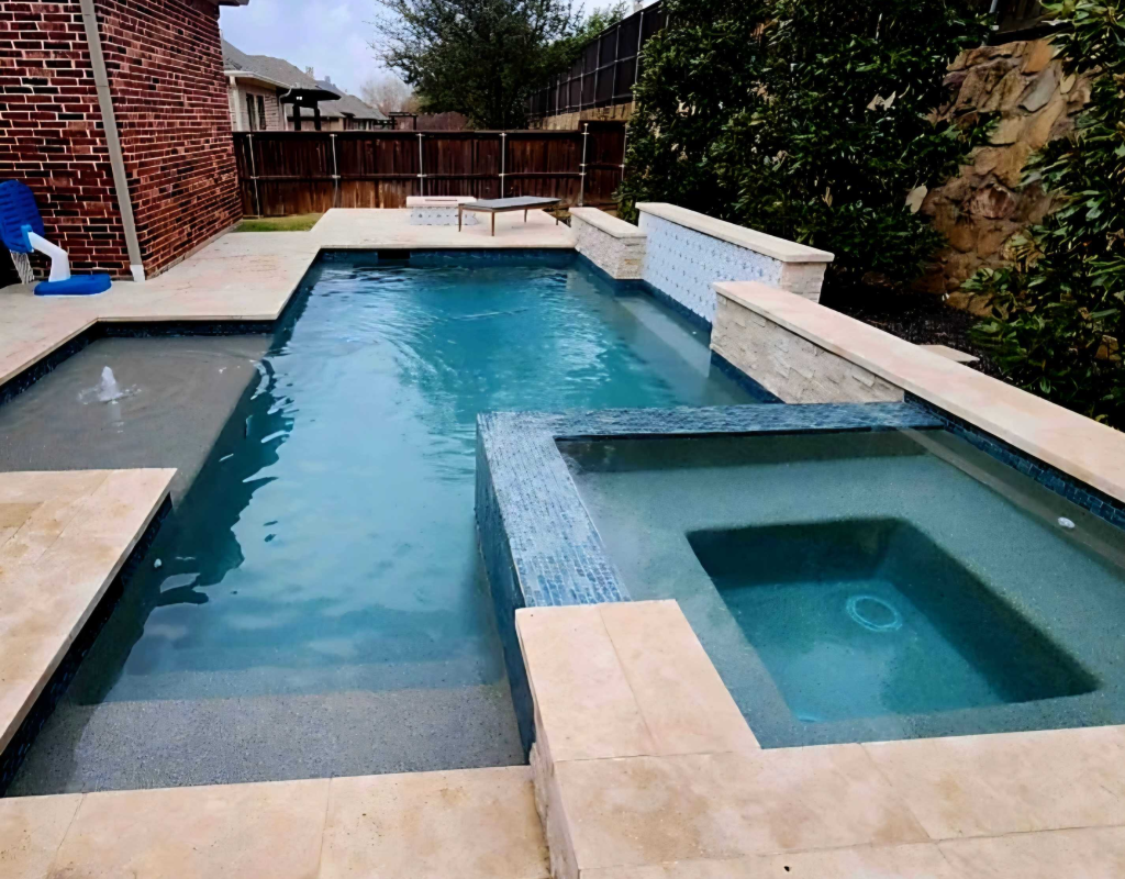 Modern pool remodel featuring spa spillover, new tile, and ambient lighting in Denton, TX